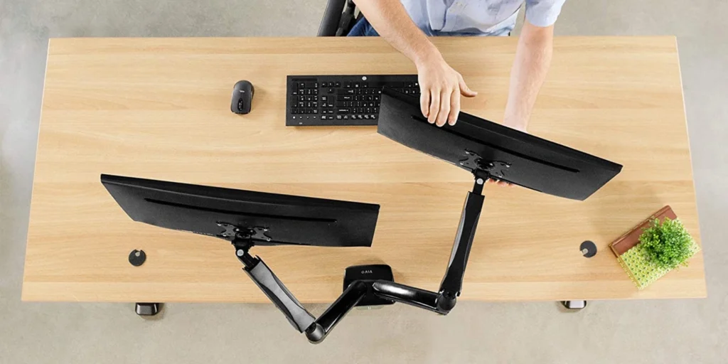 Person sitting at a desk with two monitors, best monitor stand , Vivo dual monitor stand