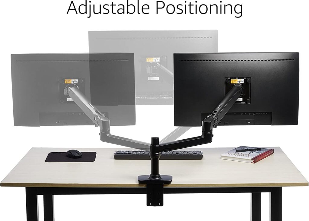 Two computer monitors sitting on top of a wooden desk. The monitors are both adjustable and can be positioned in a variety of ways.