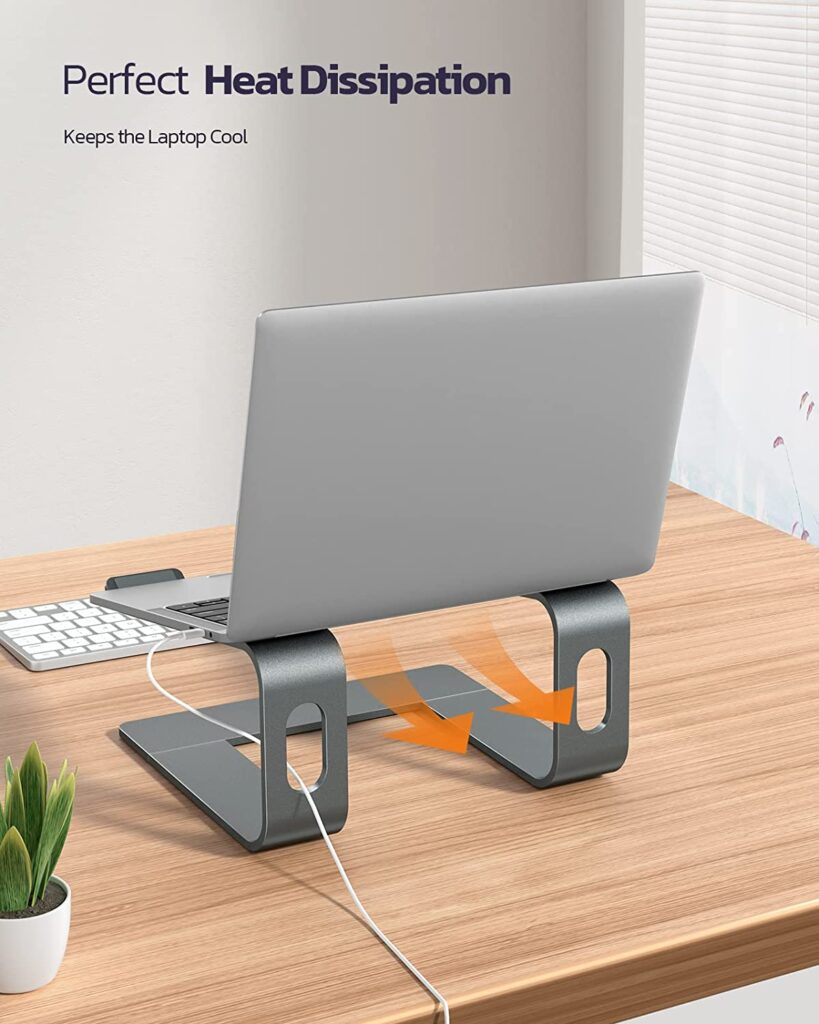 A laptop sitting on a desk next to a keyboard. The laptop is open and the text "Space Management" is visible on the screen. - productcruise.com, nulaxy laptop stand