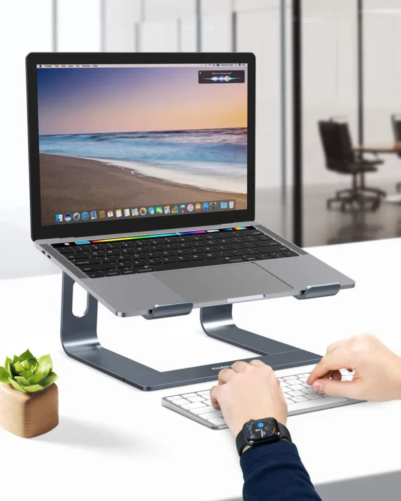 Laptop on desk with keyboard, best laptop stand