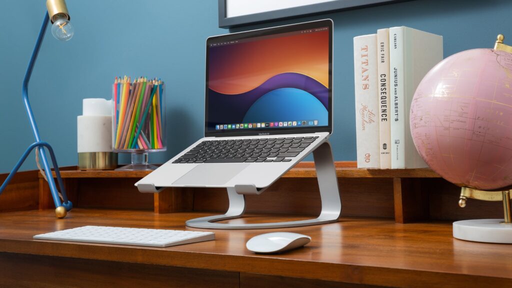 A MacBook mounted on a stand with a curved design, best laptop stand, Twelve South Curve Stand for MacBook