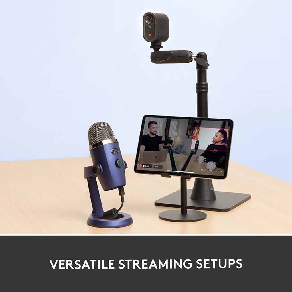 A microphone sitting on top of a desk next to a tablet with the text "VERSATILE STREAMING SETUPS", Logitech MEVO Start