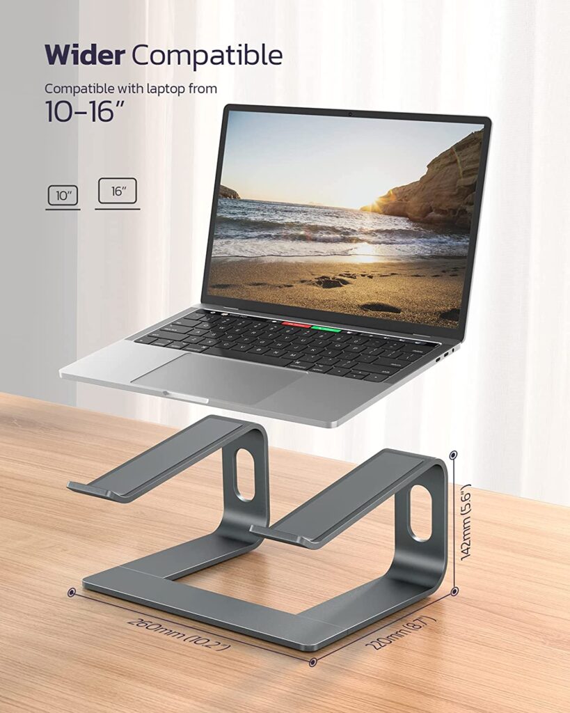 A laptop sitting on a wooden table with a laptop stand underneath it. The laptop stand is made of aluminum and has a black finish. The laptop is open and has a black screen. - productcruise.com